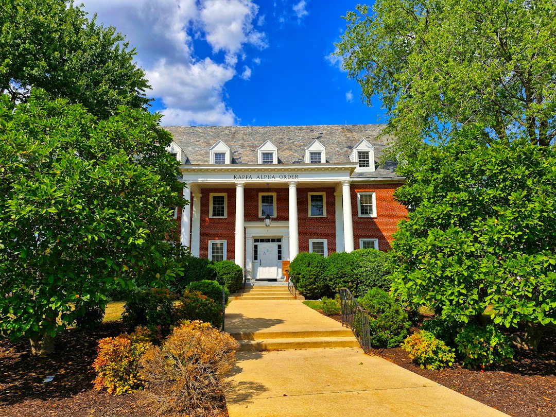 Large brick Maryland house surrounded by trees representing property tax assessment value